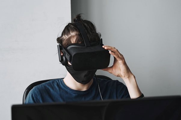 a person wearing a virtual reality headset, engaged in exploring ai management challenges and risks.